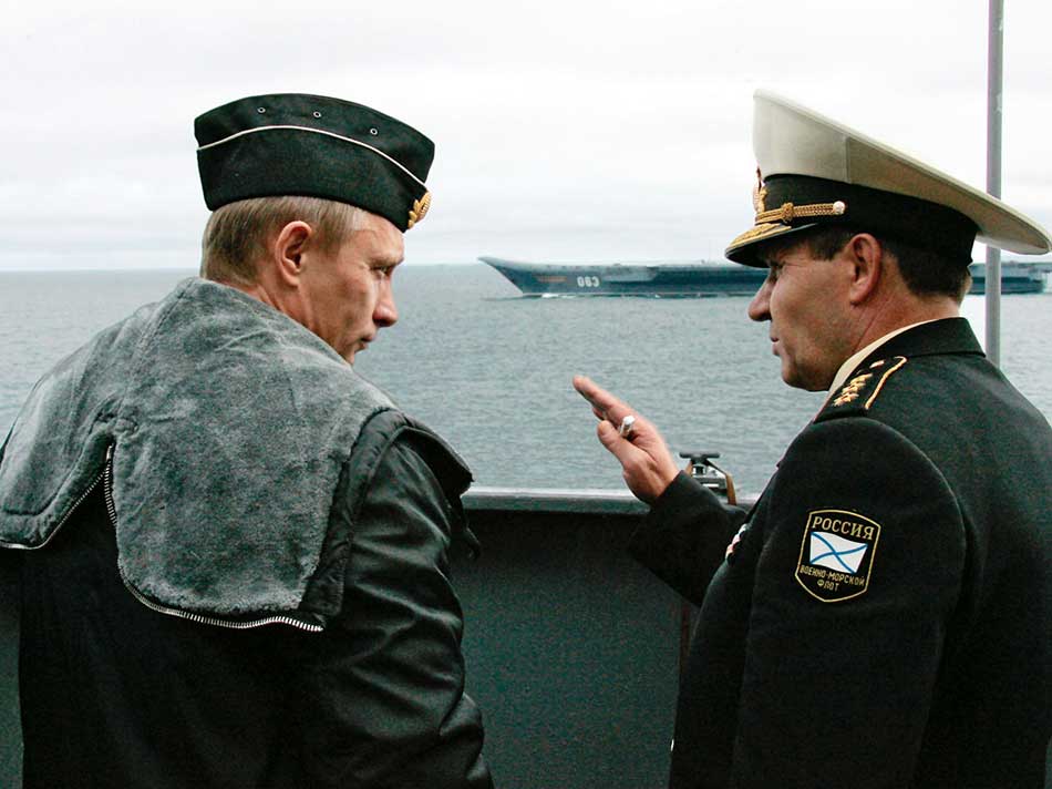 Russian President Putin and Defence Minister Ivanov share a joke while visiting military exercises in the Russia's Arctic North on board nuclear missile cruiser Pyotr Veliky. Photo: REUTERS/ITAR-TASS