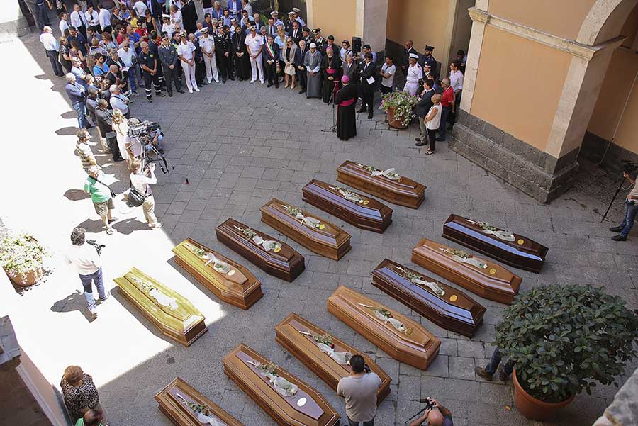 Coffins of 13 migrants who died in the worst shipwreck in the Mediterranean, on 19 April 2015, are seen during an inter-faith funeral service in Catania, Italy. More than 700 people, most of them locked below deck, were believed to have drowned(Antonio Parrinello/Reuters)