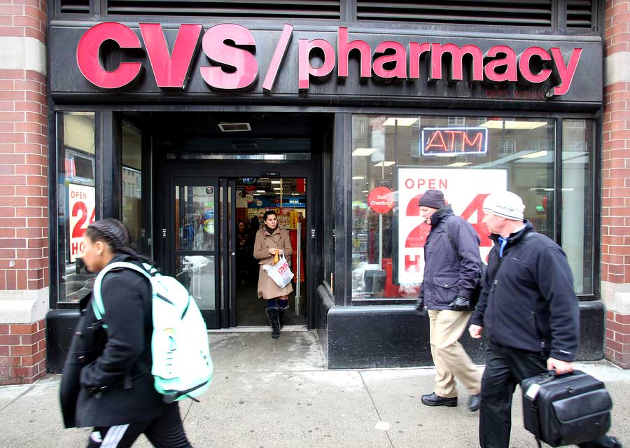 Smokers walk past a CVS Pharmacy n New York City on Tuesday, February 18, 2014. CVS is the retail division of CVS Caremark.