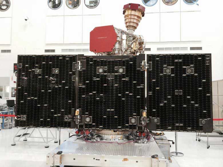 The unfolded solar arrays to power SMAP and the golden feedhorn for its radar and radiometer are visible in this image taken during assembly and testing. Credits: NASA