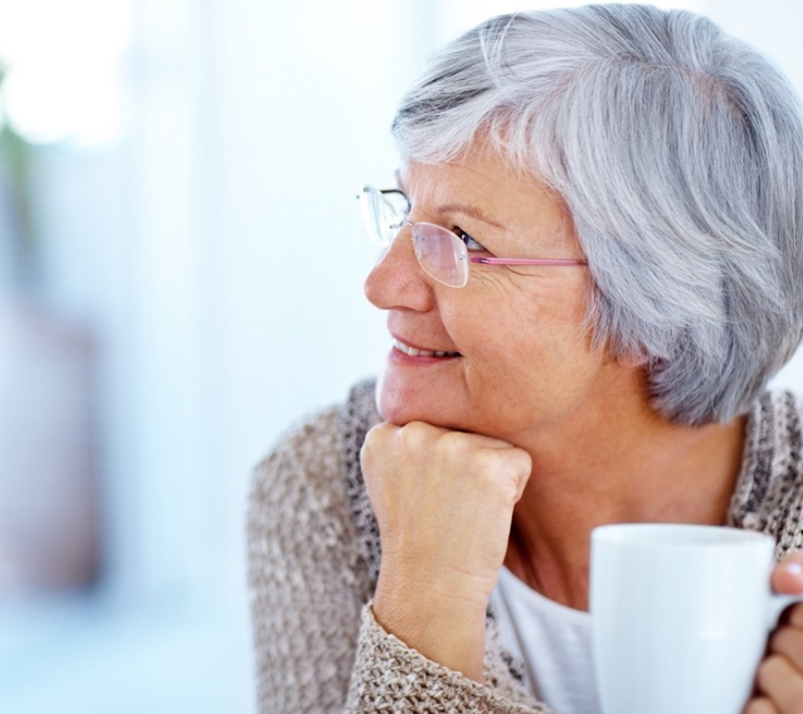 Elderly woman drinking coffee
