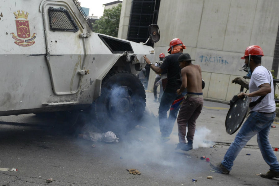 On Wednesday, during a clash between the National Guard and opposition masked protesters in Altamira, a neighborhood in Caracas, an armored tank ran over one of the protesters. Image credit: Federico Parra / Getty Images / Univision