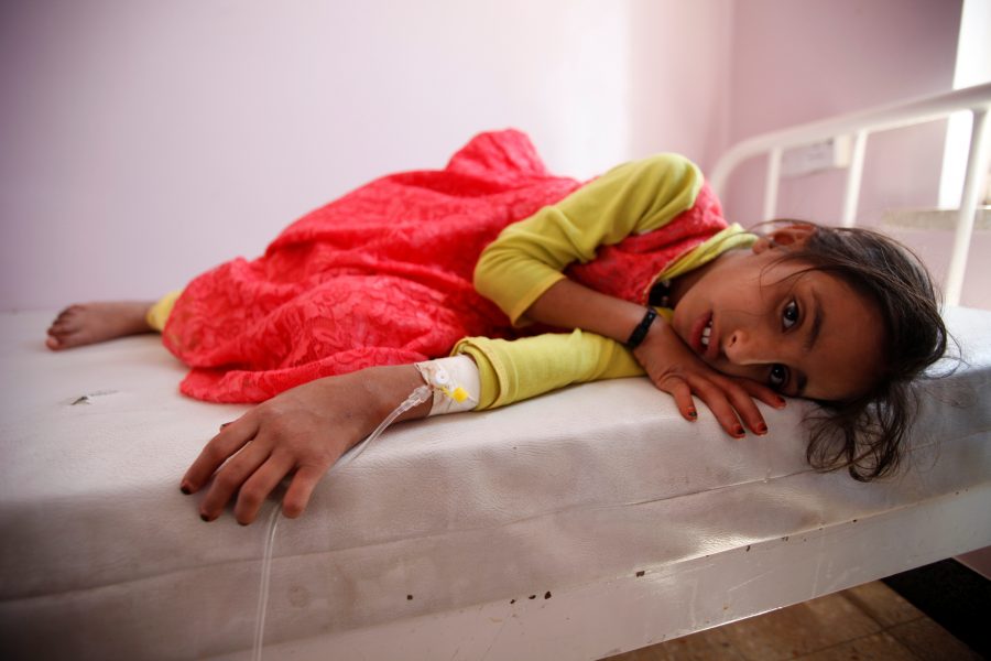 Girl lies on a bed at a hospital where she is receiving treatment for cholera amid confirmation by the UNICEF and the World Health Organization of an outbreak of the epidemic in Sanaa, the capital of Yemen